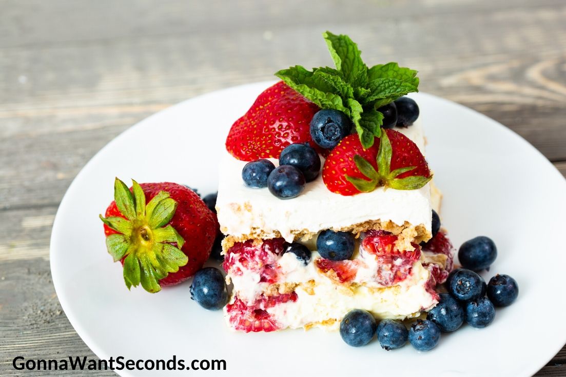 Summer berry icebox cake topped with berries, on a plate