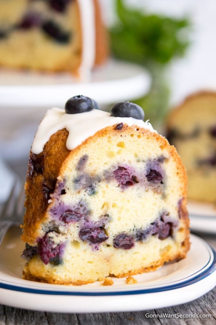 A slice of Blueberry Coffee Cake topped with fresh blueberries 