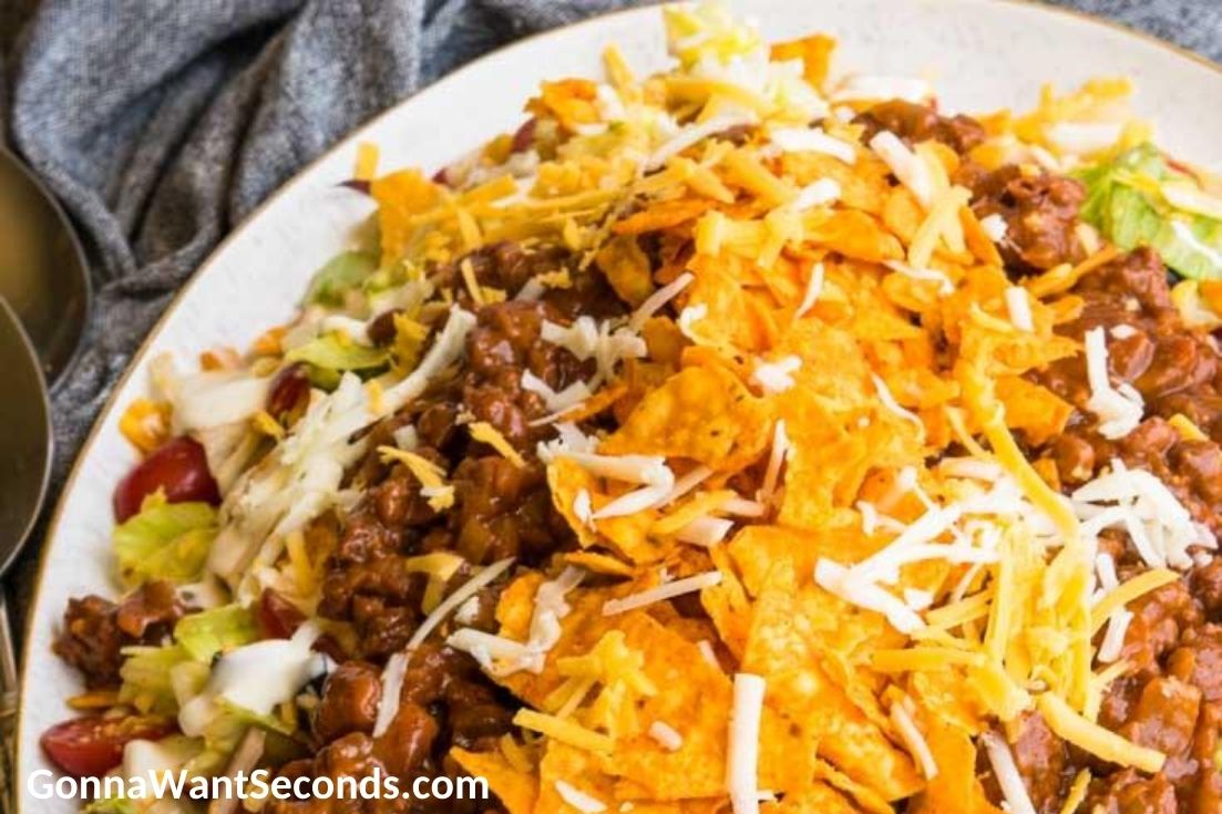 Dorito taco salad with ranch dressing on a serving plate