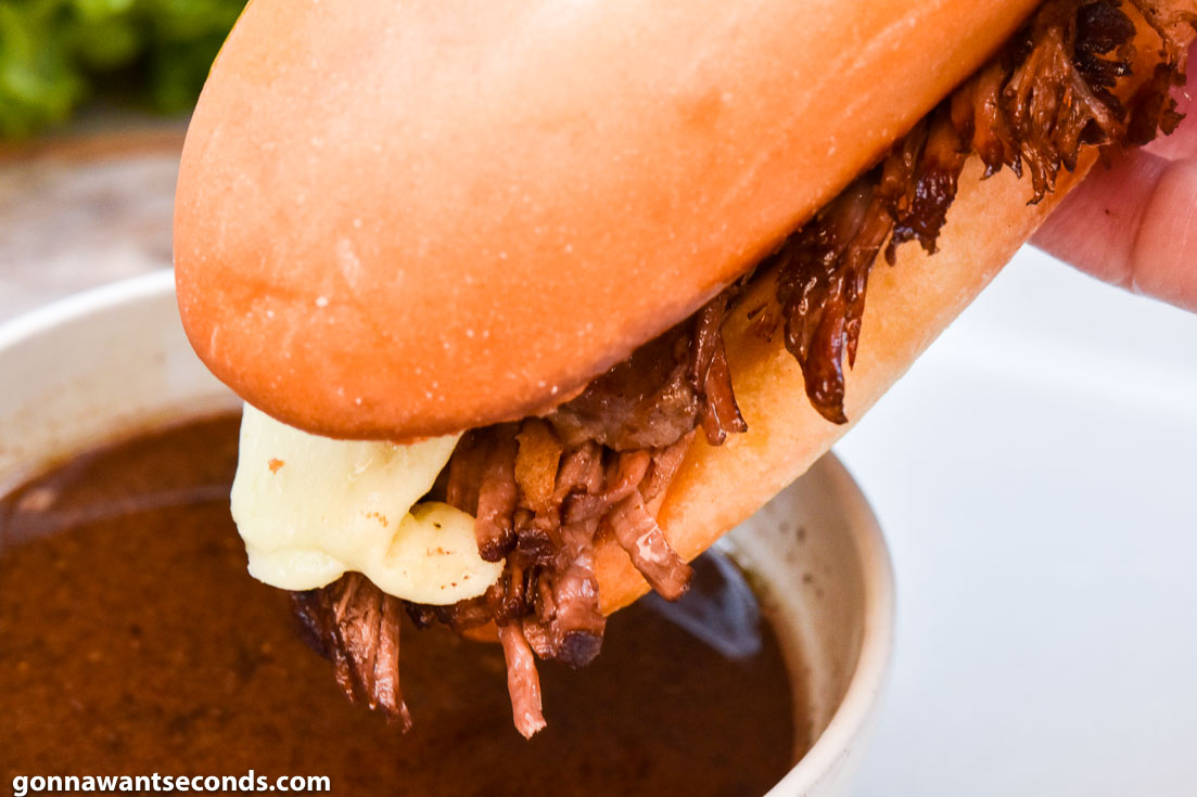 French Dip Sandwiches dipping in sauce