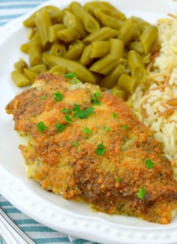 Parmesan crusted chicken with green beans and rice on the side