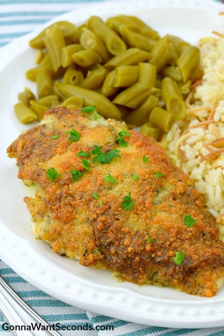 Parmesan crusted chicken with green beans and rice on the side
