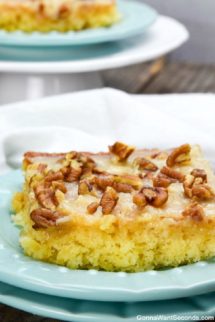 a slice of pineapple sheet cake topped with coconut pecan icing