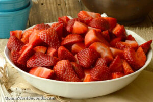 how to make fresh strawberry cobbler step 2, coat, toss, and transfer the strawberries in the baking dish