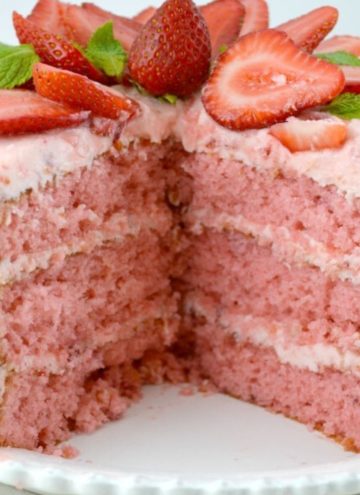 Whole strawberry layer cake sliced exposing layers