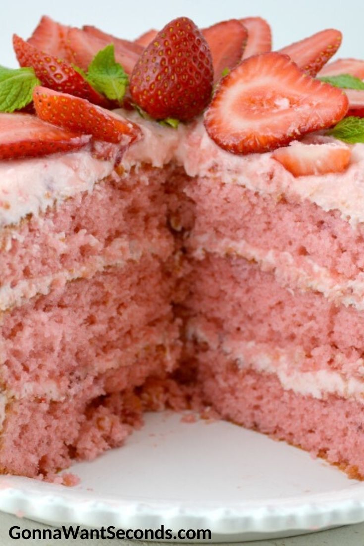 Whole strawberry cake sliced exposing layers
