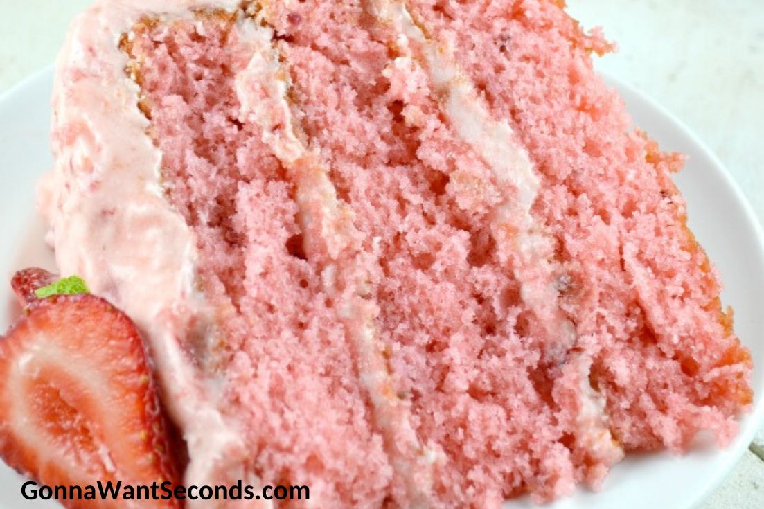 A slice of strawberry layer cake on a plate