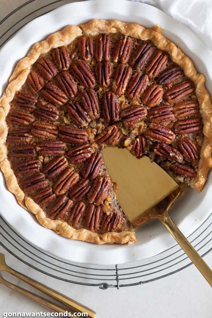 Whole pecan and pie with a slice taken out 