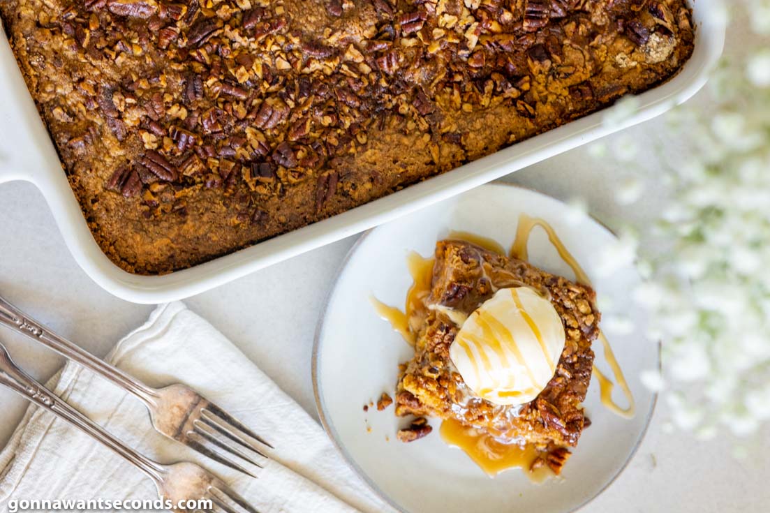 pumpkin dump cake with cake mix, topped with vanilla ice cream and drizzled with caramel