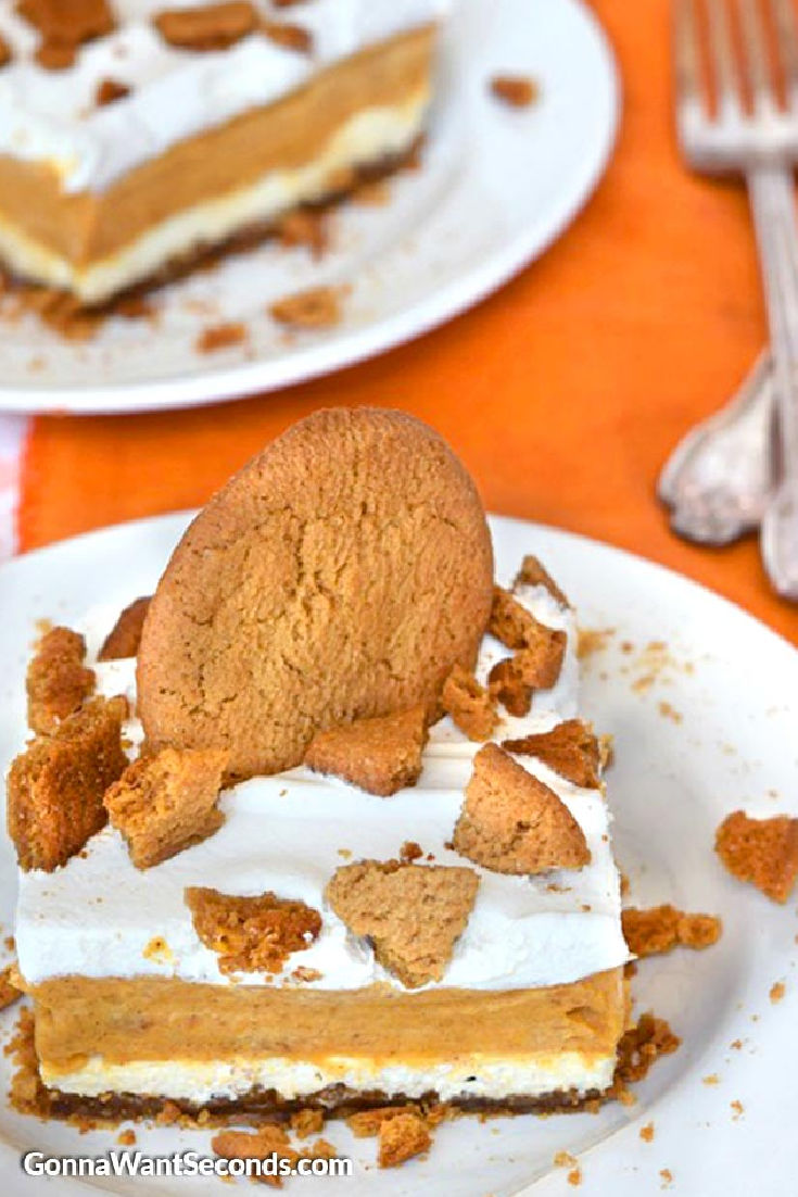 A slice of pumpkin lasagna dessert topped with crushed ginger snaps