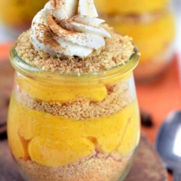 Pumpkin parfait topped with whipped cream in a parfait glass