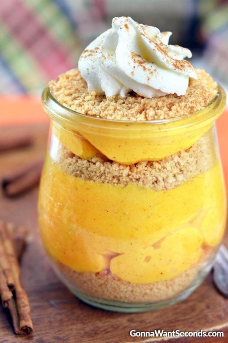 Pumpkin parfait topped with whipped cream in a parfait glass
