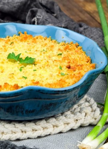 Scalloped corn in a blue baking dish, close up