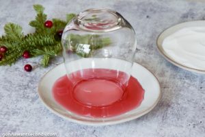 How to make Cranberry Margarita, dipping the rim of glass in syrup