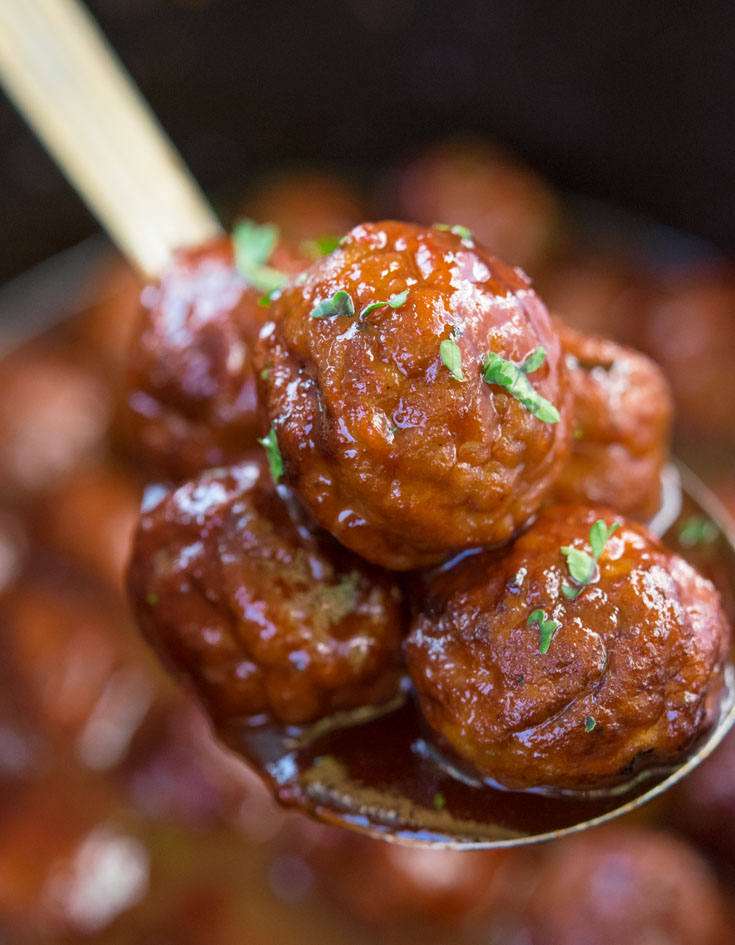 Ladle scooped Grape Jelly Meatballs from crockpot