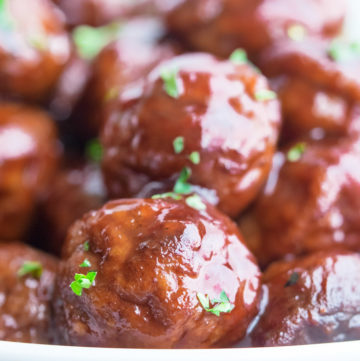 Grape Jelly Meatballs in a shallow white bowl