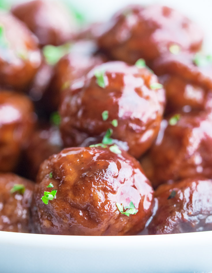 Grape Jelly Meatballs in a shallow white bowl