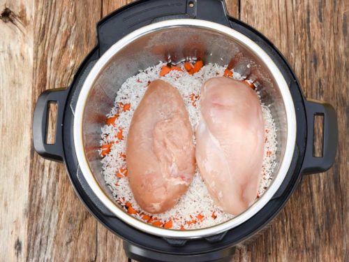 How to make Instant Pot chicken and rice, adding ingredients to the pot