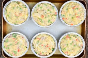 How to make KFC chicken pot pie, scooping mixture into individual pie pans