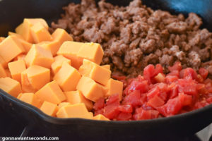 How to make Rotel Dip, mixing all ingredients in the skillet