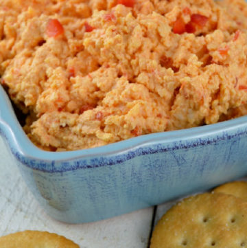 Pimento Cheese in a blue bowl with crackers on the side