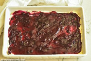 Step 8 How to make Blueberry Yum Yum, spreading the blueberry filling on top of the cream cheese mixture