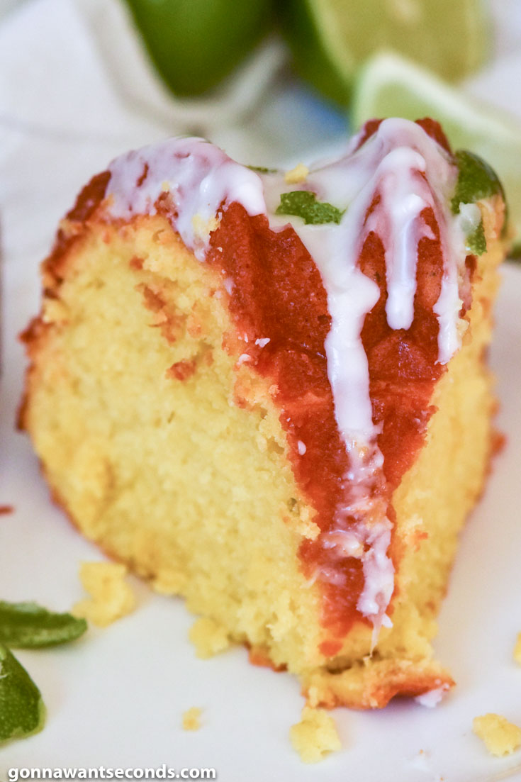 A slice of Margarita Cake with glaze and lime peel on top