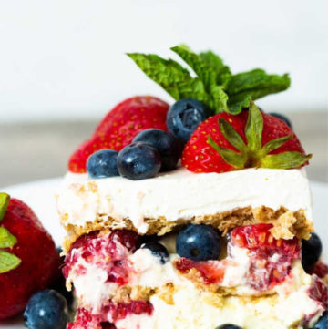 Summer Berry Icebox Cake topped with fresh berries and mint sprigs