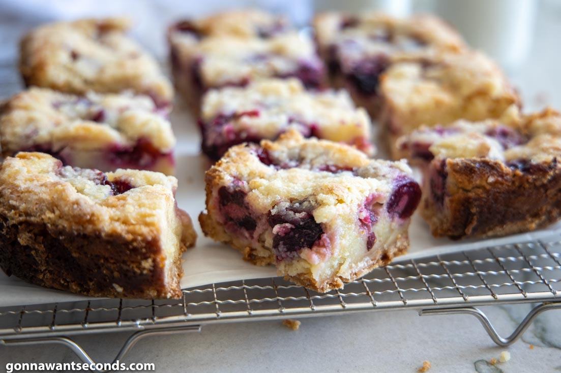 Slices of cherry Custard Pie Bars on a cooling rack