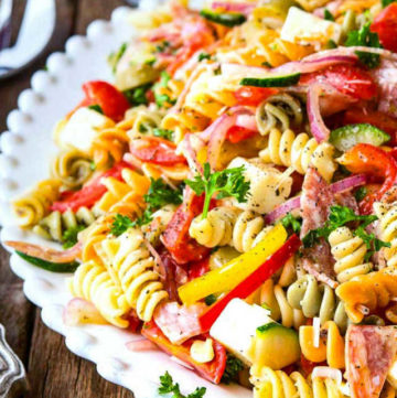 This pasta salad recipe has a zesty vinaigrette dressing, spiral pasta and crisp summer veggies for a classic dish that welcomes every single taste bud
