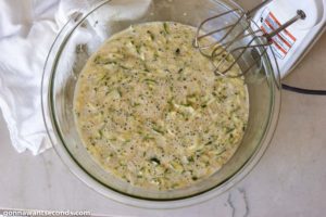 How to make Zucchini Bread, mixing the dry and wet ingredients and zucchini