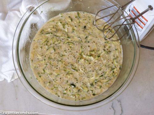 How to make Zucchini Bread, mixing the dry and wet ingredients and zucchini