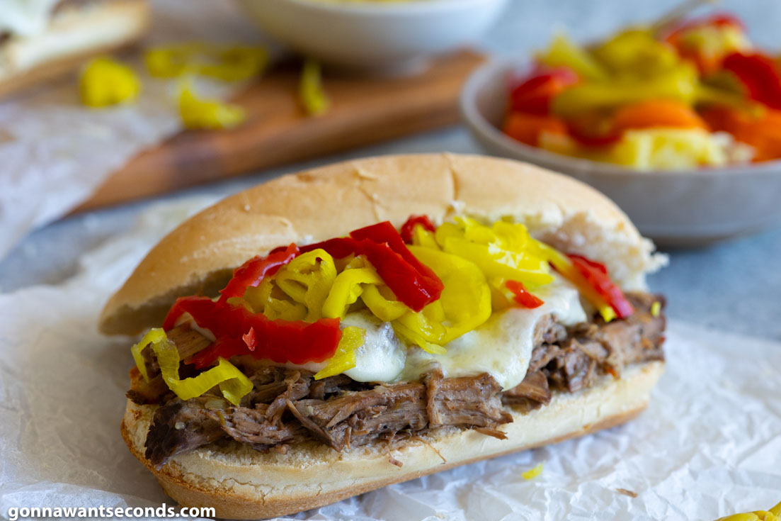 crockpot Italian beef sandwiches, topped with pepperoncini and extra Giardiniera