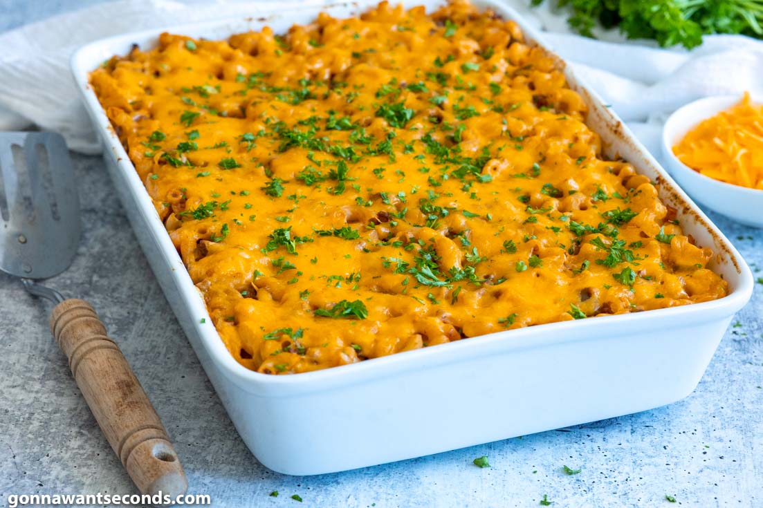 sloppy joe casserole topped with cheese, in a baking dish