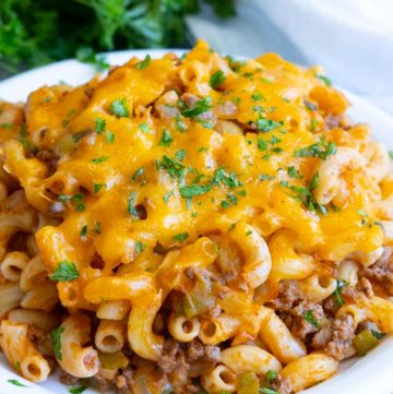 sloppy joe casserole topped with melted cheese, on a plate