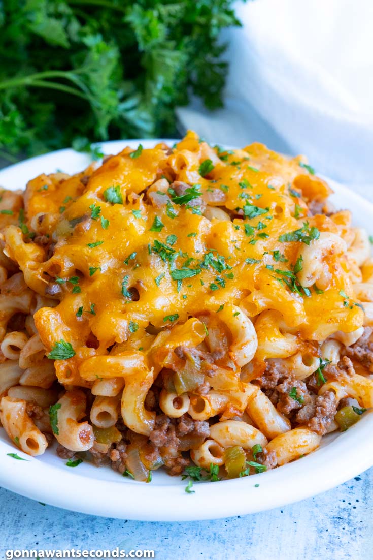 sloppy joe casserole topped with melted cheese, on a plate