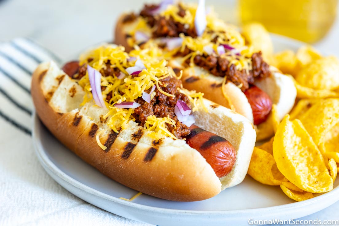 hot dog chili in a bun with cheese on top