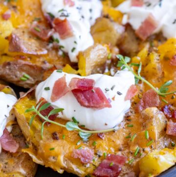 loaded crispy smashed potatoes topped with sour cream and bacon