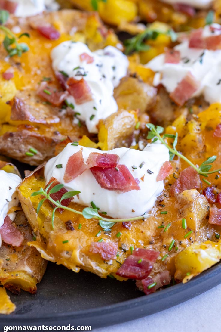 loaded crispy smashed potatoes topped with sour cream and bacon