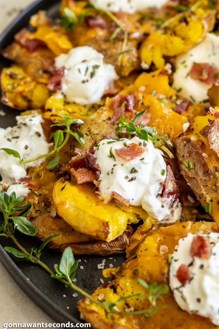 crispy smashed potatoes topped with sour cream and bacon