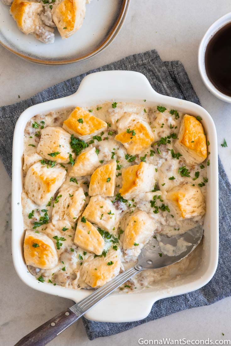 biscuits and gravy breakfast casserole in a casserole dish, top shot