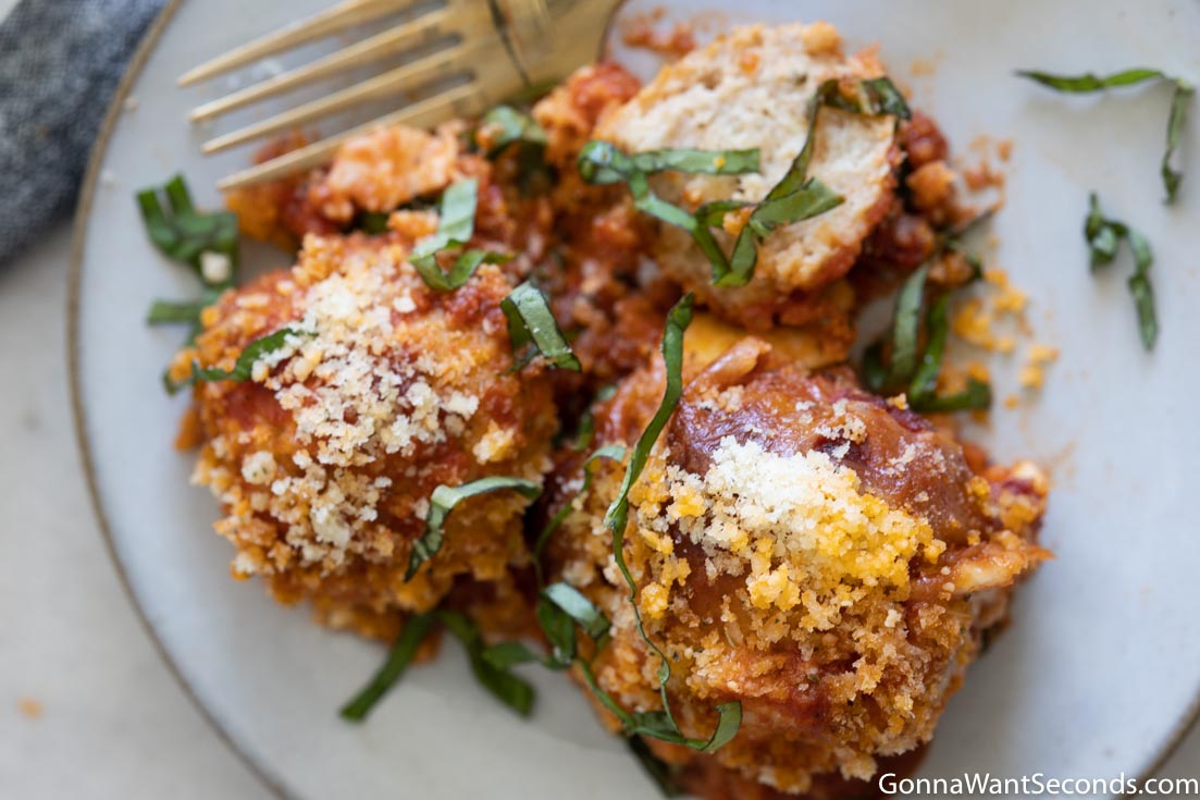 parmesan chicken meatballs on a plate with garnish on top