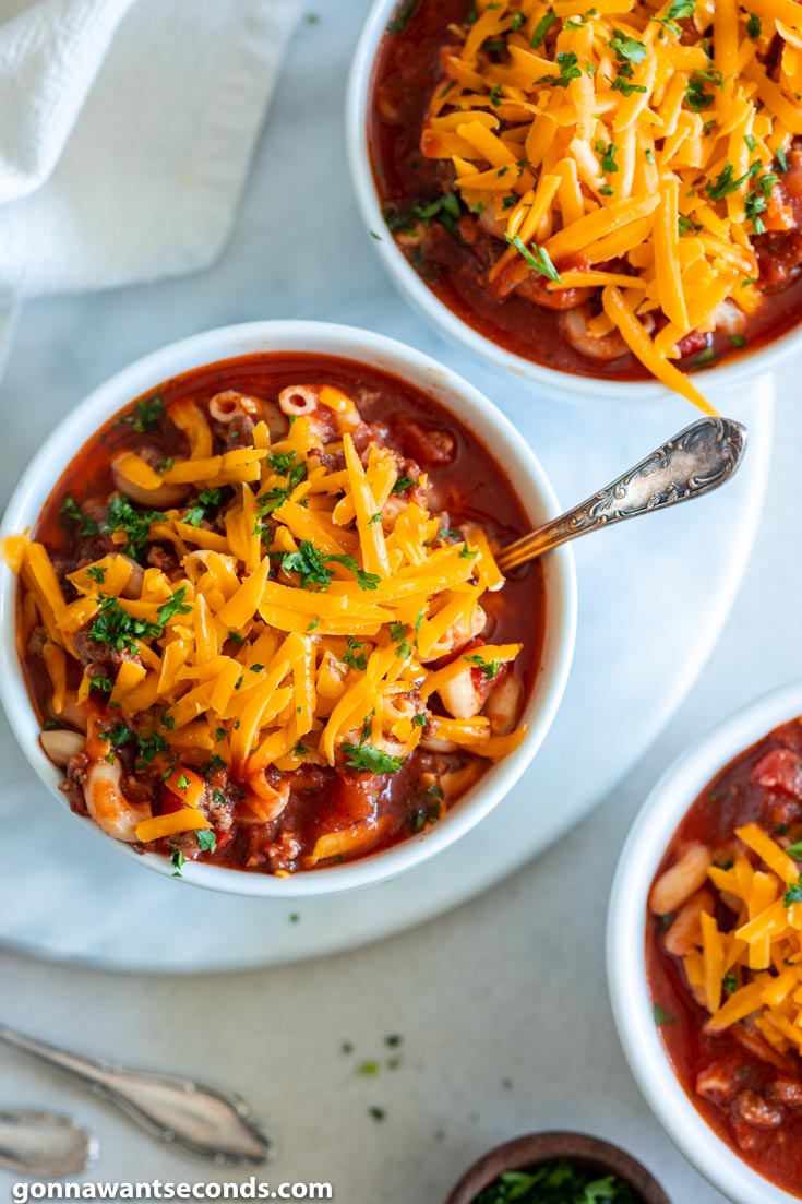 Bowls of crockpot goulash with cheese, top shot
