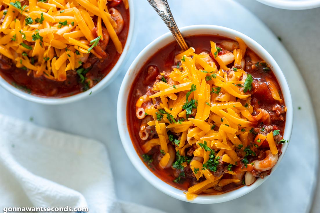 crockpot goulash with cheese on a bowl, top shot
