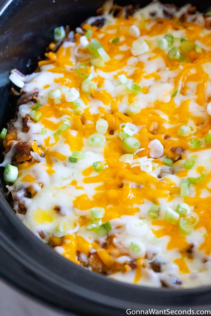 crock pot breakfast casserole topped with melted cheese 