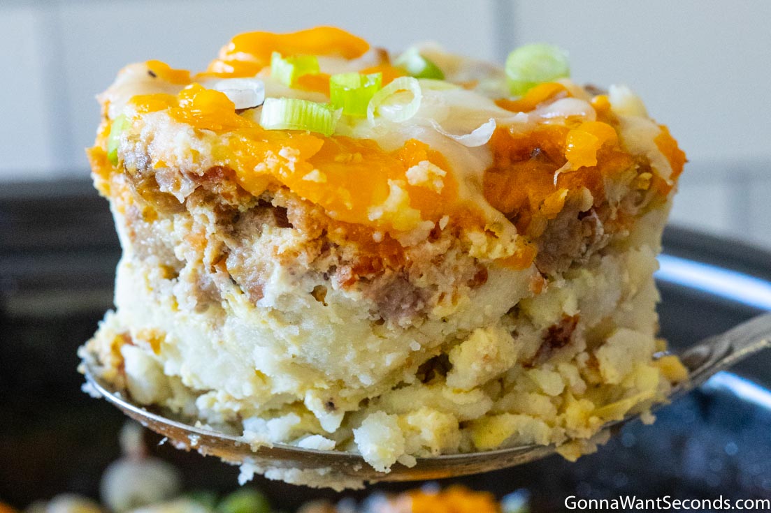 A scoop of crockpot breakfast casserole with sausage, close up