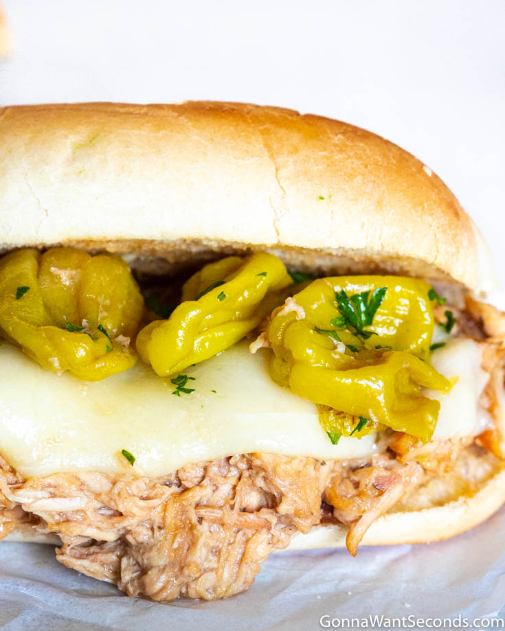 how to serve mississippi chicken sandwiches, topped with cheese and pepperoncini