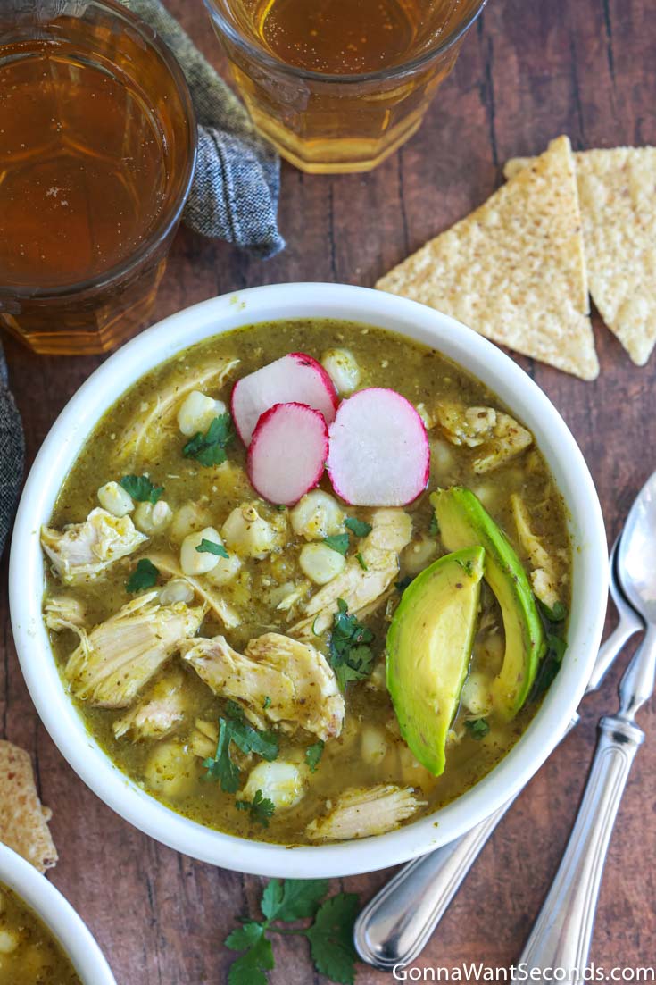 mexican pozole verde, topped with sliced avocados and radishes, top shot