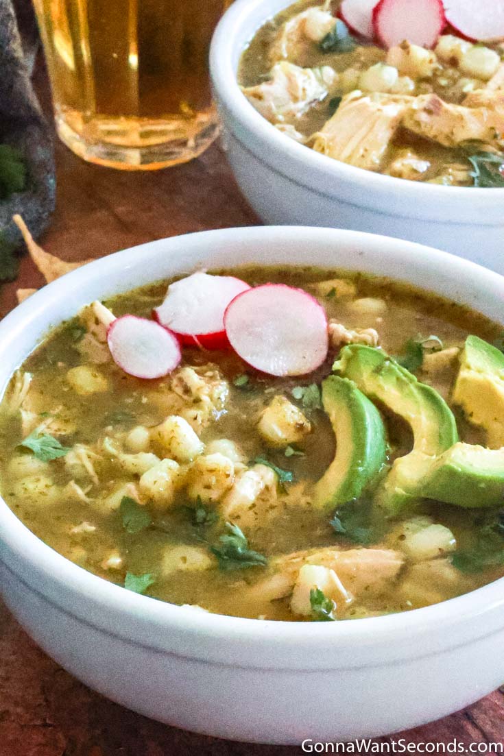 chicken pozole verde, topped with sliced avocados and radishes