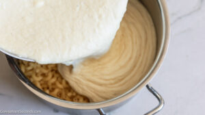 How to make creamy smoked gouda mac and cheese, pouring the cheese sauce on to the pasta